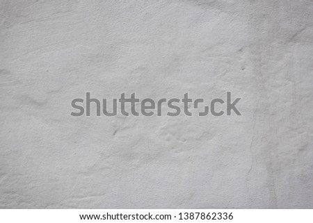 The texture of the old concrete wall with scratches, cracks, dust, crevices, roughness, stucco. Can be used as a poster or background for design.