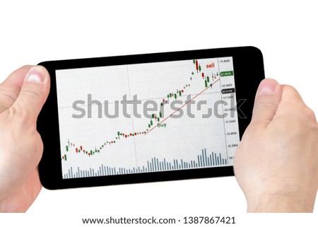 tablet with stock charts in hand. tablet in hand isolated on white background .