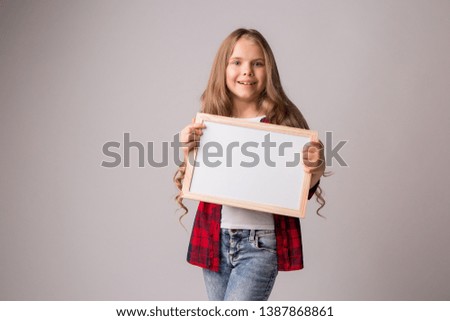 teen girl in casual clothes holding a blank white sheet, isolate, space for text,Portrait of beautiful young woman with blank paper sheet on white background