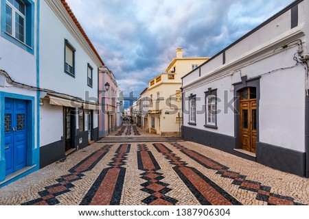 Street in the old town in the center of Lagos, Algarve region, Portugal. Narrow street in Lagos, Algarve, Portugal. Streets in the historic old town of Lagos, Algarve, Portugal. Royalty-Free Stock Photo #1387906304