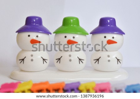 beautiful snowman with colorful  caps