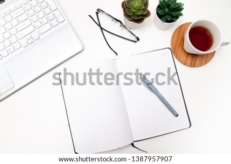 Workspace with laptop, notebook, sketchbook, succulent, cup of tea on white background. Flat lay, top view office table desk. Freelancer working place. copyspace.