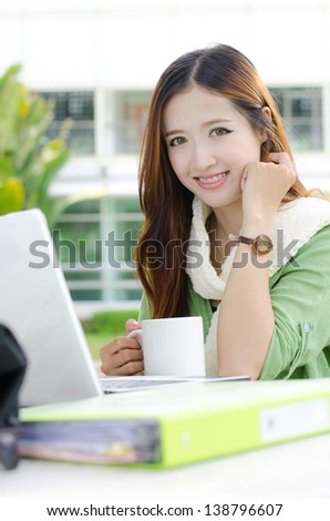 Asian women student looking and smiling with coffee cup