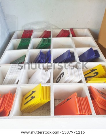 Colored plastic sheet with numbers in White wooden box.