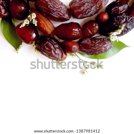Selective focus. Date fruits on the white table. Greeting card for Muslim holy month Ramadan Kareem. Festive background. Empty space. Flat lay, top view