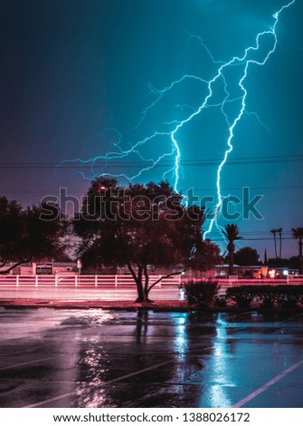 Lightning hitting a parking lot at midnight Royalty-Free Stock Photo #1388026172