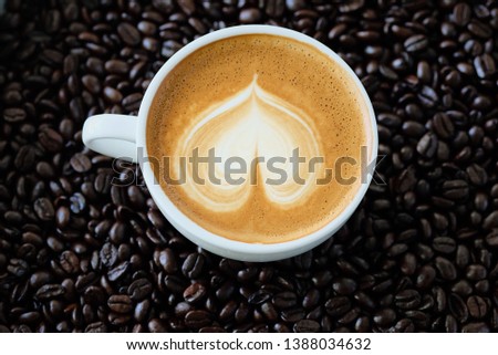 a cup of coffee latte on coffee bean roasted