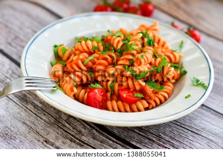  Home made italian  fusilli  pasta  with  tuna  , parmesan cheese   , tomato and fresh parsley. Mediterranean food concept
