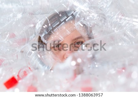 Dehydrated sick woman is lying in a pile of plastic bottles. Environmental pollution problem. Stop nature garbage environment protection concept