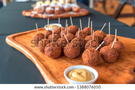 Bitterballen - Dutch meat based snack , typically containing a mixture of beef . butter and flour for thickening Includes  parsley , salt and pepper.  Royalty-Free Stock Photo #1388076050