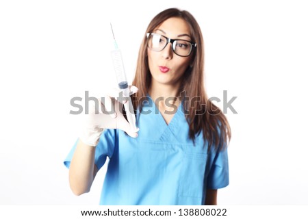 Very expressive doctor with a syringe in the hands
