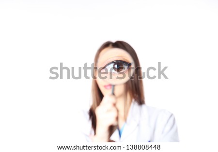 Doctor holding a magnifier in the eye
