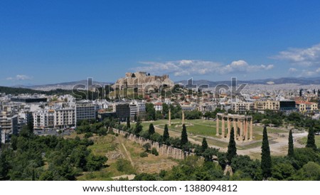 Aerial drone photo of iconic pillars of Temple of Olympian Zeus and world famous Acropolis hill with masterpiece Parthenon on top at the background, Athens historic centre, Attica, Greece
