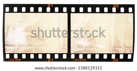 real macro photo of 35mm film snip with two empty frames or cells on white background, just blend in your photos here to get that old film effect Royalty-Free Stock Photo #1388129315
