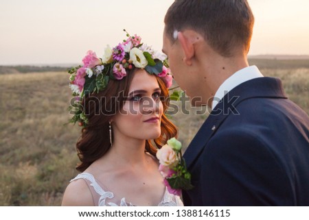 the bride and groom walk at sunset