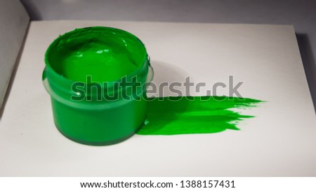 green paint can and paint smear