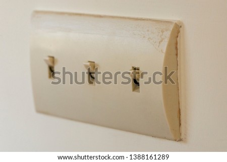A 3 way electrical light switch on the wall in a residential home