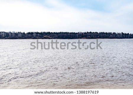 Landscape on the river in the evening, ripples on the surface of the water.
