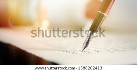 Notary signs legal contract. Close up of fountain pen on paper Royalty-Free Stock Photo #1388202413