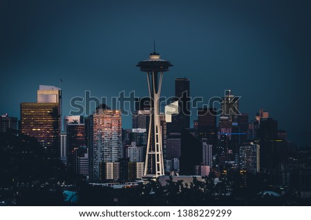 Photo of downtown Seattle during a beautiful summer evening in Washington, featuring the iconic Seattle Space Needle standing out from the skyline