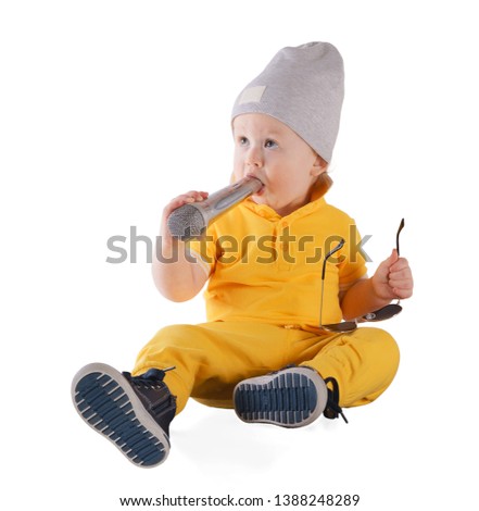 Stock photo of little boy holding microphone, isolated on white