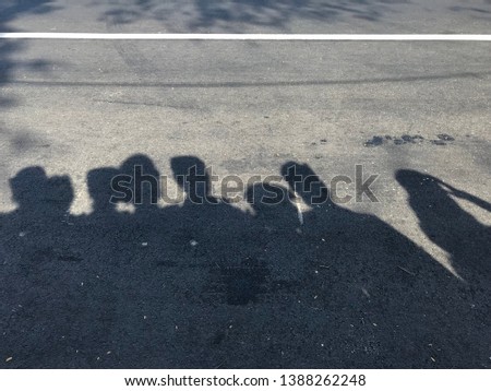 Shadow of people standing on the street in the morning. 