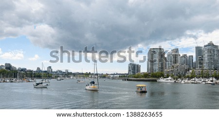 panoramic summer view of Vancouver city with thunderclouds and bay with yachts, British Columbia Canada