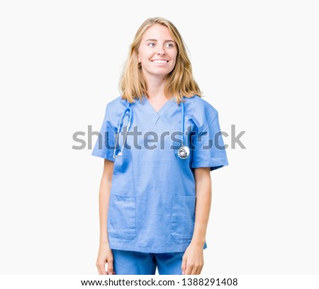 Beautiful young doctor woman wearing medical uniform over isolated background looking away to side with smile on face, natural expression. Laughing confident.