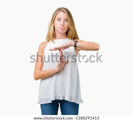 Beautiful young elegant woman over isolated background Doing time out gesture with hands, frustrated and serious face