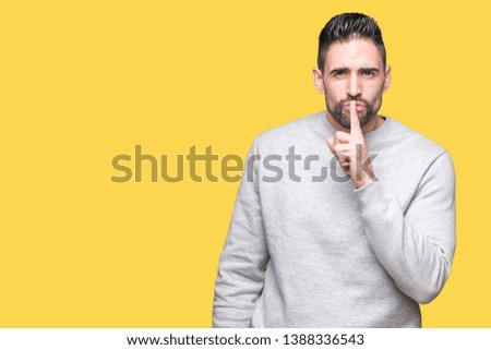 Young handsome man wearing sweatshirt over isolated background asking to be quiet with finger on lips. Silence and secret concept.