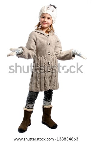 Little girl in knitwear smiling standing isolated on white