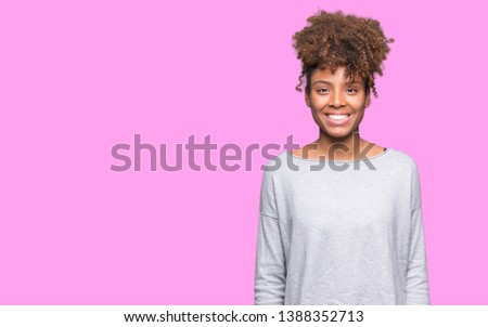 Beautiful young african american woman over isolated background with a happy and cool smile on face. Lucky person.