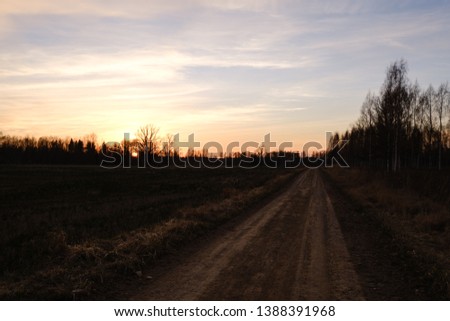 beautiful countryside gravel road in sunset. Latvia, spring