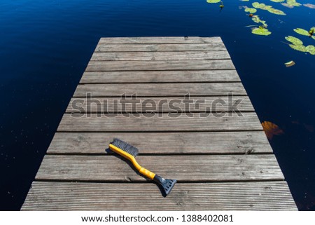 wooden plank foothpath boardwalk trampoline in the lake with blue water in summer