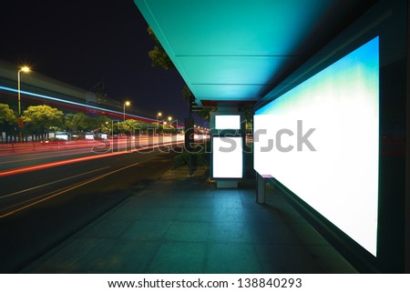 Road car light trails through at modern city advertising light boxes