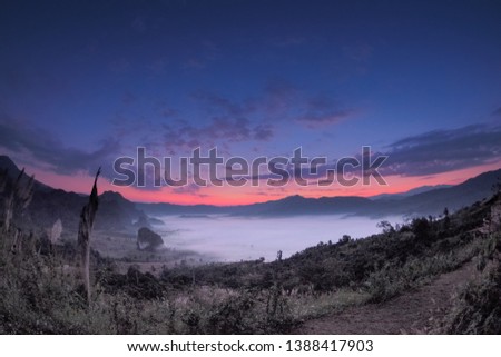 sunrise at Phu Langka, Photo Corner View Point, mountain view sea of fog in valley around with forest and the hills with red sky background, Phu Langka, route 1148, Phayao, Thailand.