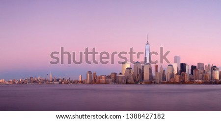 New York City skyline panorama with skyscrapers over Hudson River at sunset viewed from New Jersey