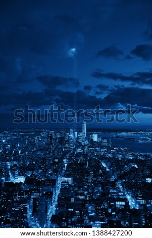 New York City downtown skyline view at night with September 11 tribute light.