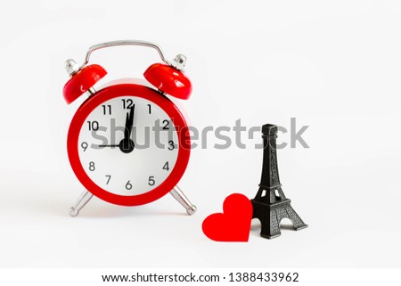 Romantic trip to Paris concept. Honeymoon, time to fall in love. Invitation to a romantic trip, a love note. Eiffel tower with red alarm clock