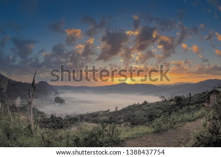 sunrise at Phu Langka, Photo Corner View Point, view scenic sea of fog in valley around with high mountains with yellow sun light and cloudy sky background, route 1148, Phayao, northern of Thailand.