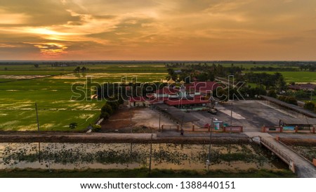 An aerial view of scenic sunset over paddy field