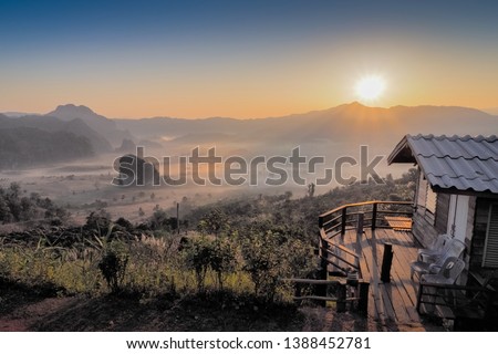 sunrise at Phu Langka, Photo Corner View Point, view of wooden house on side hill with sea of fog and sunrise background, Phu Langka, Route 1148, Phayao, Thailand.