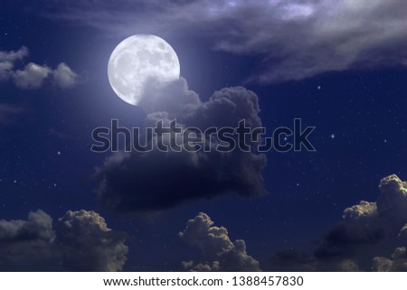 
Mystical full moon with cumulus clouds in a starry sky, dramatic sky