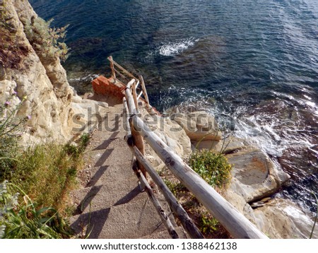 the long and steep staircase leading down to the sandstone cliff of promontory inside the port of agropoli cilento italy Royalty-Free Stock Photo #1388462138