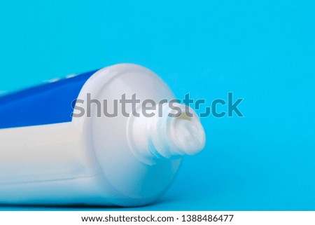 Tube of toothpaste on a blue background.
