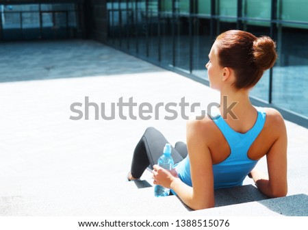 Young, fit and sporty brunette girl in sportswear. Woman doing sports outdoor.