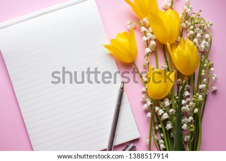 notebook mockup with tulips and lilies of the valley . 