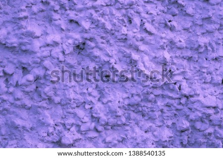 
Violet background texture of structural facade plaster macro photo. Large beautiful wall surface relief with a roof plan. Textured plaster with a very uneven relief, a lot of bumps and grooves.