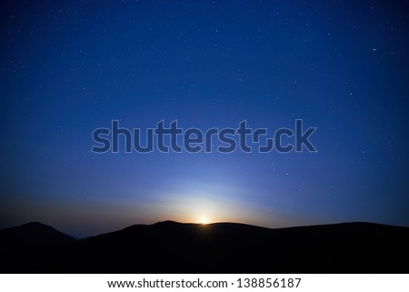 Blue dark night sky with many stars. Moon rising. Space background