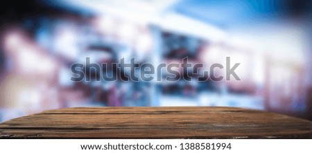 Table background of free space for your decoration and blurred bar. Night club interior. 